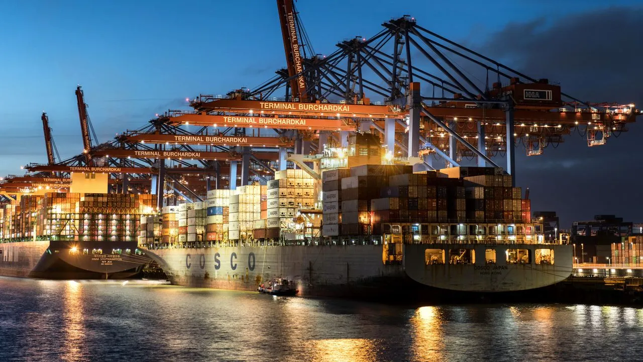 Container ship and terminal cranes lit up at night