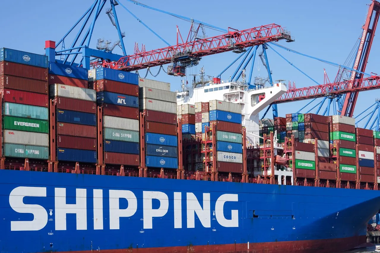 Large container ship at a terminal with quay cranes